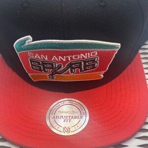 Mitchell & Ness Black Snapback Hat with Red Brim and Multi-Color Spurs Patch